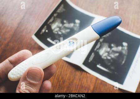 Positive pregnancy test in womans hand. Stock Photo