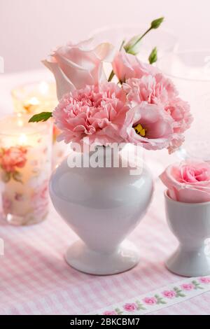 Beautiful bouquet in pink and white in vase on the kitchen table Stock Photo