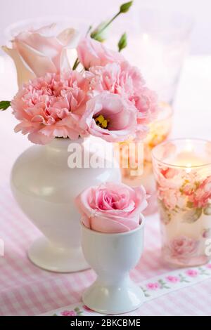 Beautiful bouquet in pink and white in vase on the kitchen table Stock Photo