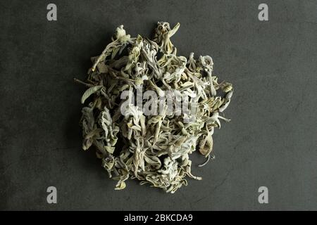 Dry sage leaves on stone background. Healthy and organic tea. Flat lay, top view. Stock Photo
