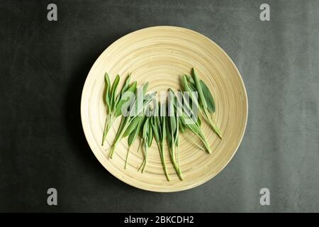Fresh sage leaves on wooden plate. Freshly harvested and organic herbal tea. Overhead, top view, flat lay. Stock Photo