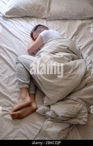 Young caucasian man sleeping in his bed Stock Photo
