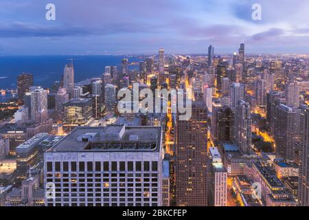 Chicago skyline panorama aerial view with skyscrapers over Lake Michigan with cloudy sky at dusk. Stock Photo