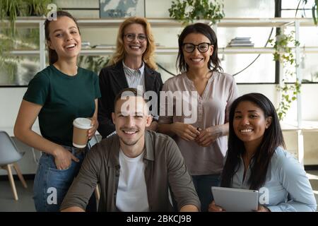 Portrait of happy smiling diverse mixed race employees team standing. Stock Photo