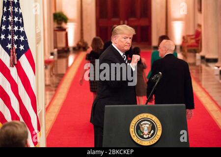 President Donald J. Trump gestures with a fist pump Monday, Oct. 8, 2018, at the conclusion of the swearing-in ceremony for newly sworn-in U.S. Supreme Court Associate Justice Brett M. Kavanaugh in the East Room of the White House in Washington, D.C. The Swearing-in Ceremony of the Honorable Brett M. Kavanaugh Stock Photo