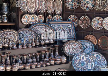 Bosnia and Herzegovina, Mostar - June 2018: Decorative enamelled plates on sale to tourists at a local street bazaar Stock Photo