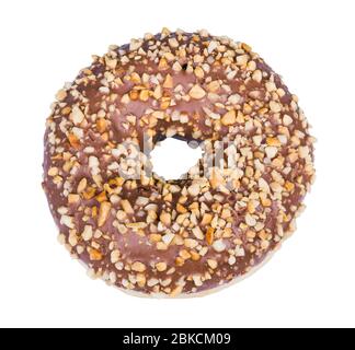 Baked donut decorated with nougat icing and crushed nuts isolated on white background. One sweet doughnut with round hole, cocoa glaze and nut pieces. Stock Photo