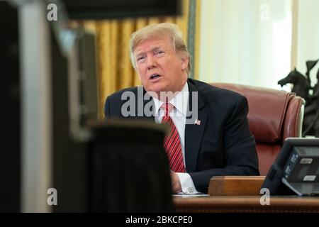 President Donald J. Trump participates in a Christmas Day video teleconference from the Oval Office Tuesday, December 25, 2018, speaking with military service members stationed at remote sites worldwide to thank them for their service to our Nation. President Donald J. Trump participates in a Christmas Day video teleconference from the Oval Office Stock Photo