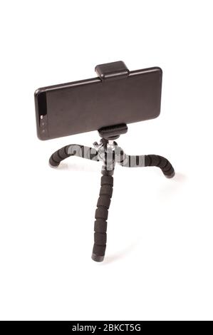 Adjustable universal smart phone tripod for remote recording and podcast isolated on the white background Stock Photo