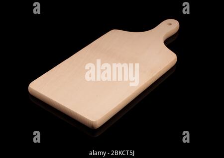 Wooden cutting board kitchen equipment isolated on the black reflective background Stock Photo