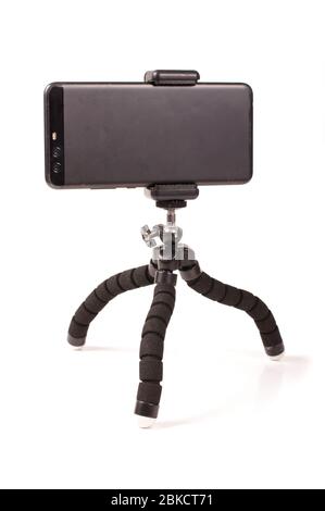 Adjustable universal smart phone tripod for remote recording and podcast isolated on the white background Stock Photo