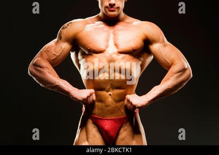 Portrait of a handsome muscular bodybuilder posing over black background. -  Stock Image - Everypixel