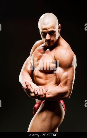 Young Handsome Muscular Man Bodybuilder Posing In The Studio On A White  Background Stock Photo, Picture and Royalty Free Image. Image 63466898.