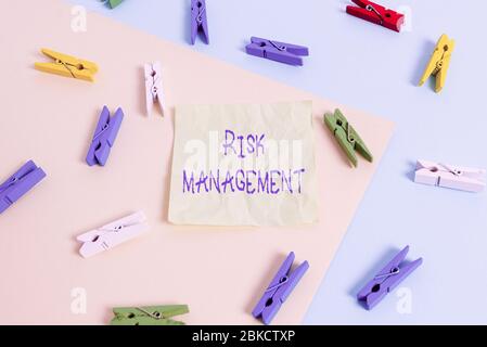 Writing note showing Risk Management. Business concept for evaluation of financial hazards or problems with procedures Colored clothespin paper remind Stock Photo