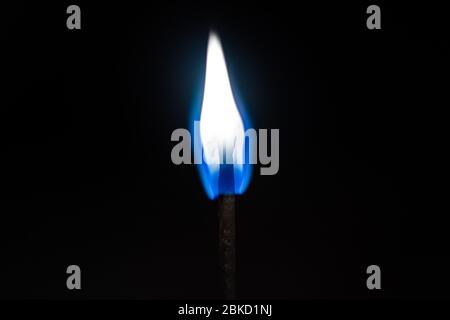 Burning match lighting flame isolated on a black background Stock Photo