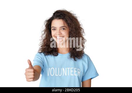 Happy hispanic teen girl volunteer shows thumbs up isolated on white background. Stock Photo