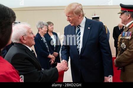 President Donald J. Trump, joined by Britain’s Queen Elizabeth II,  meets with World War II veterans and their families during a D-Day National Commemorative Event Wednesday, June 5, 2019, at the Southsea Common in Portsmouth, England. President Trump Attends a D-Day National Commemorative Event Stock Photo