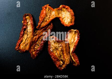 Sun dried tomatoes on a black background Stock Photo