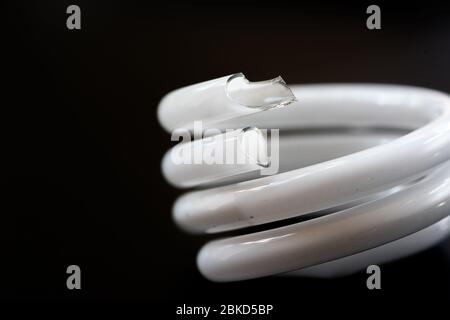 Broken CFL bulb closeup macro Stock Photo