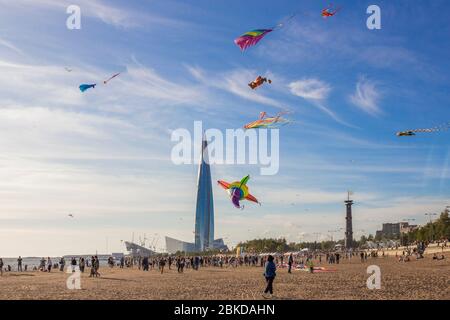 Saint Petersburg, Russia - August 31, 2019. People walking around, colorful ribbons and kite figures hanging on poles and flying in the blue sky Stock Photo