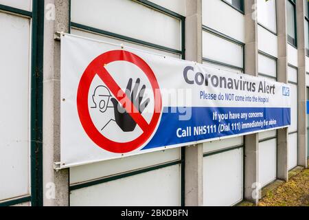 Banner sign outside Ashford hospital in Stanwell, Hounslow with a Coronavirus Alert request not to enter the hospital Stock Photo