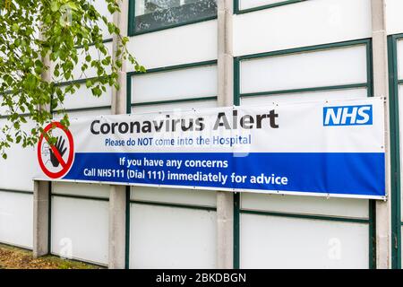 Banner sign outside Ashford hospital in Stanwell, Hounslow with a Coronavirus Alert request not to enter the hospital Stock Photo