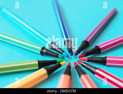 Rainbow palette of felt-tips Colorful markers are lying in round shape Close-up photo with blurred background Stock Photo