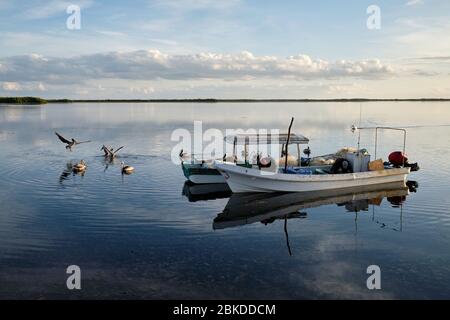 Fishermen preparing their boats and fishing gear to go fishing at sunrise. Stock Photo