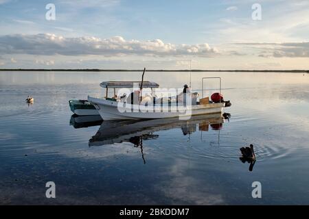 Fishermen preparing their boats and fishing gear to go fishing at sunrise. Stock Photo