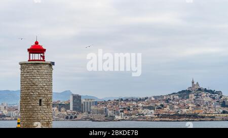 The lighthouse at the Chateau d'If overlooking the Bay of Marseille in a cloudy day, France Stock Photo
