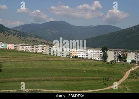 Landscape in Brasov County, Romania, with communist era apartment buildings seen in the town of Zarnesti. Stock Photo