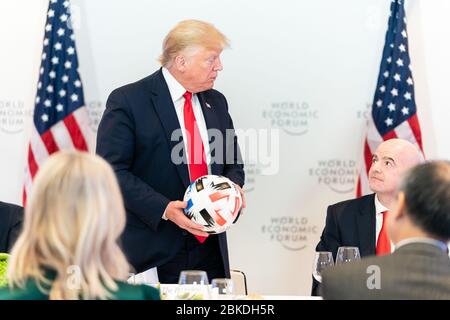 On January 21, 2020, President Donald J. Trump accepted a soccer ball from FIFA President Gianni Infantino during a dinner with global CEOs at the Davos Congress Centre in Switzerland, part of the World Economic Forum. Stock Photo