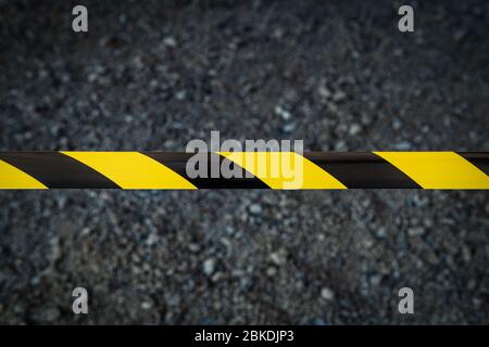 Black and yellow striped tapes on dark background. Restricted area border. Passage is forbidden. Stock Photo