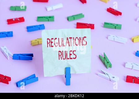 Conceptual hand writing showing Regulations Rules. Concept meaning Standard Statement Procedure govern to control a conduct Colored clothespin papers Stock Photo