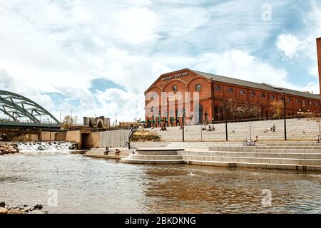 Denver, Colorado - May 1st, 2020:  REI Flagship store overlooking South Platte River and Shoemaker Plaza in Confluence Park Stock Photo