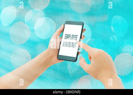 Handwriting text Employee Handbook. Conceptual photo Document that contains an operating procedures of company Stock Photo