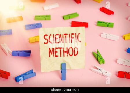 Conceptual hand writing showing Scientific Method. Concept meaning Principles Procedures for the logical hunt of knowledge Colored clothespin papers e Stock Photo