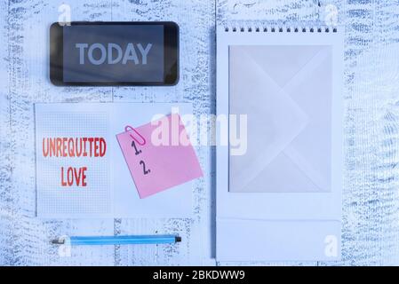 Conceptual hand writing showing Unrequited Love. Concept meaning not openly reciprocated or understood as such by beloved Spiral notebook marker smart Stock Photo