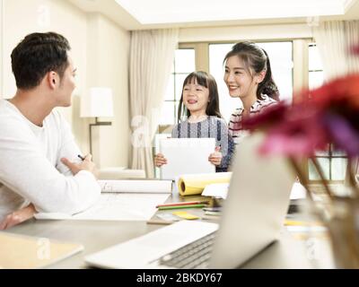 young asian family with one child staying home happy and cheerful Stock Photo