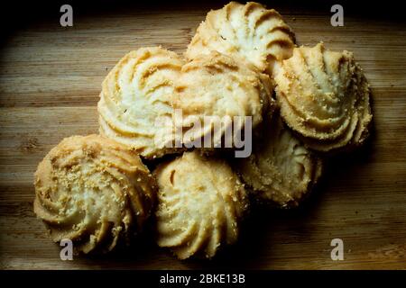 Swirl shape butter cookies in a wooden plate. Bakery cookies in swirl shape. Stock Photo