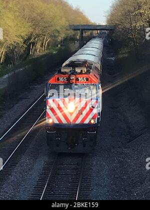 Outbound Metra Union Pacific North commuter rail train arriving at Winnetka station from Chicago. Stock Photo