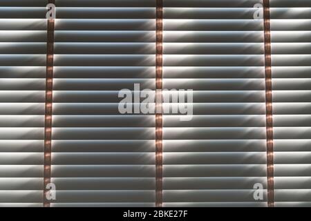 Close up. Vintage wooden shutters blinds (Windows blinds) with the light sunshine. Stock Photo