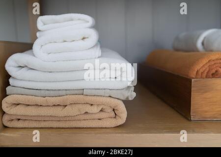 Luxury and soft towel rolled stacked in wood box. Stock Photo