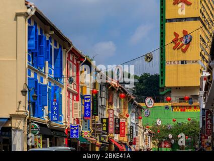 Singapore - September 08 2019: Facades of famous colorful colonial shop houses decorated with Chinese lanterns and fairy lights in Singapore Chinatown Stock Photo