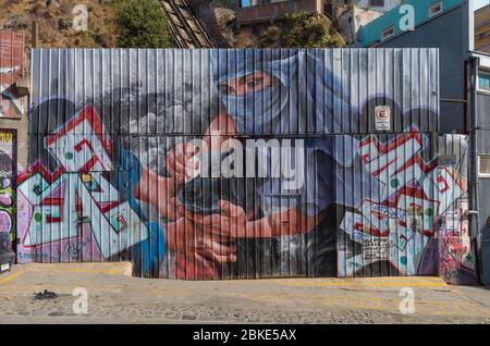 Colored graffiti, street art on the walls of Valparaiso, Chile Stock Photo