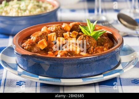 Keftedes saganaki with orzo. Meatballs in tomato and feta sauce. Greece Food Stock Photo