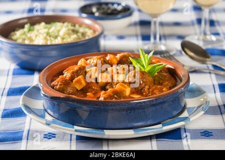 Keftedes saganaki with orzo. Meatballs in tomato and feta sauce. Greece Food Stock Photo