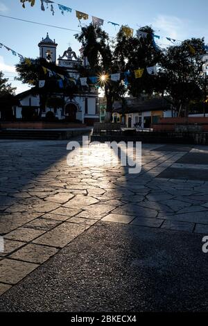 Rays of sun passing through the trees in the Plaza del Iglesia del Cerrillo in the early hours of the morning. Stock Photo