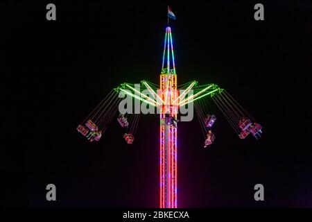 Blurry colourfull light lines from the fast moving whirligig at the Sassenheim town fair in the Netherlands. Stock Photo