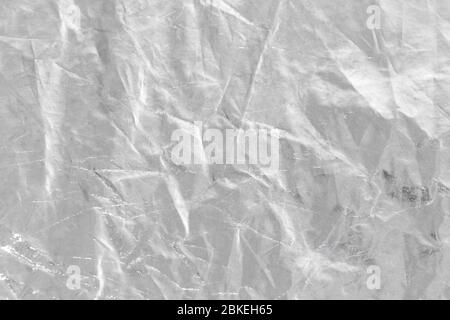 metalic Silver foil background with shiny crumpled uneven surface for texture and background Stock Photo